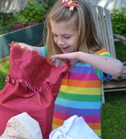 green sustainable kid's parties in Victoria BC child opening cloth bag